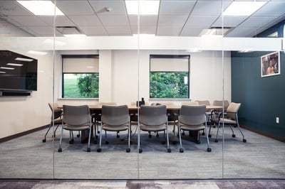 Office table and chairs with glass office walls