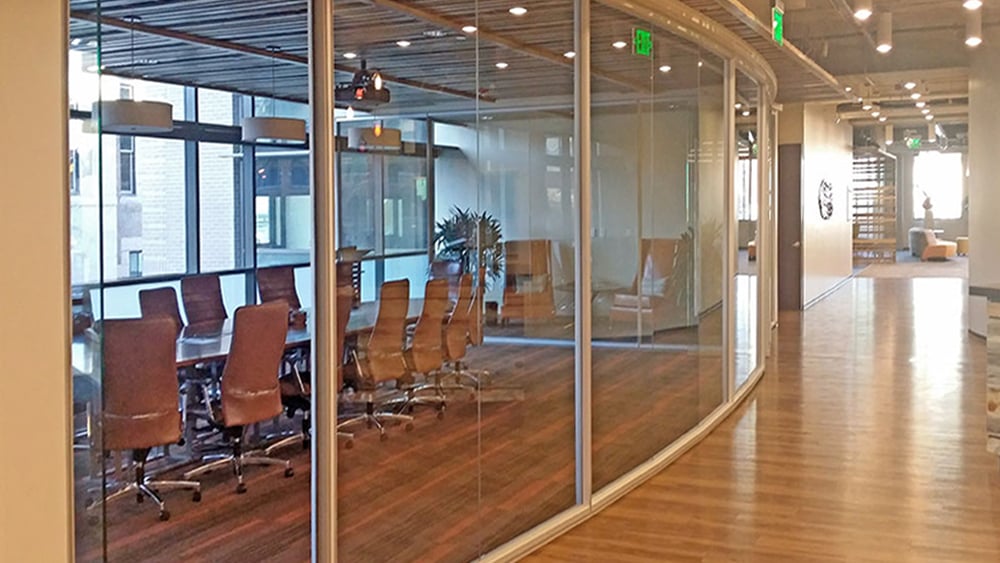 Curved glass office with hardwood floors