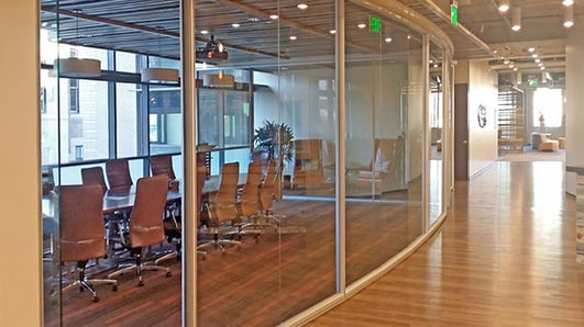 Curved glass office with hardwood floors