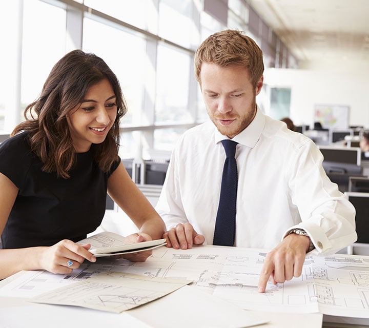 Two business workers looking at data