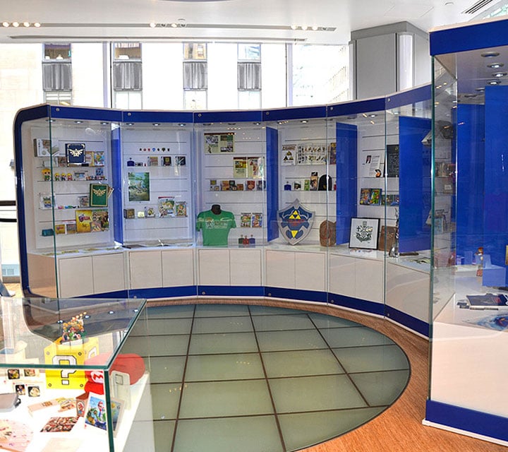 Curved glass display cases with blue accents in brightly lit retail showroom