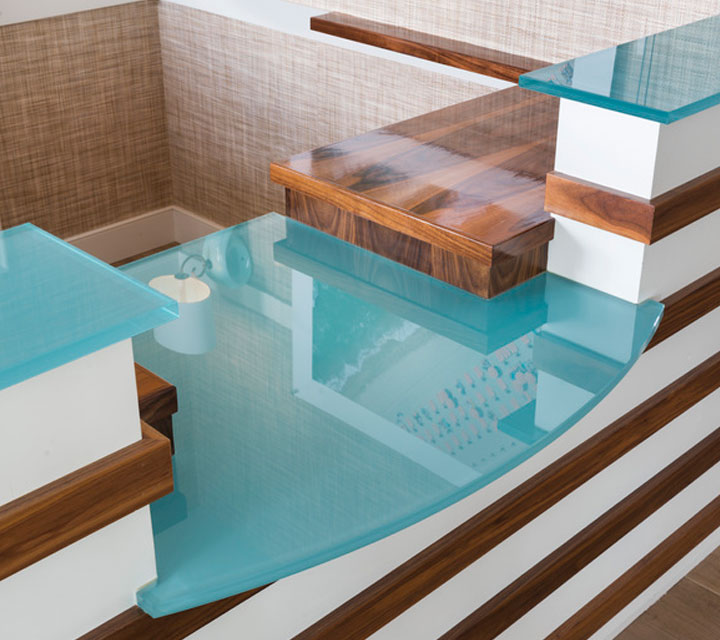 blue back painted glass at receptionist desk with hardwood and white accents
