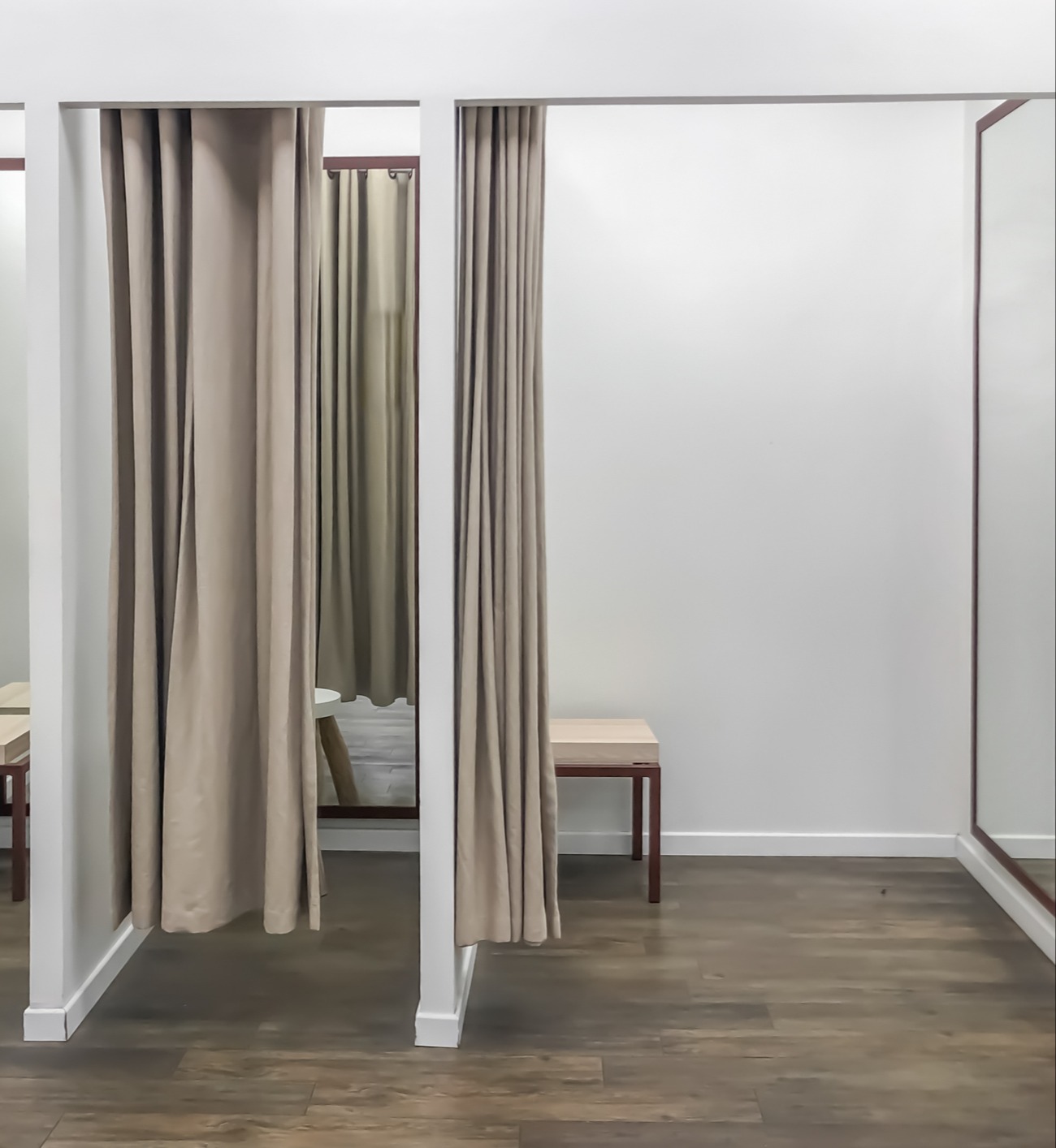Fitting room with curtains and mirrors on side walls