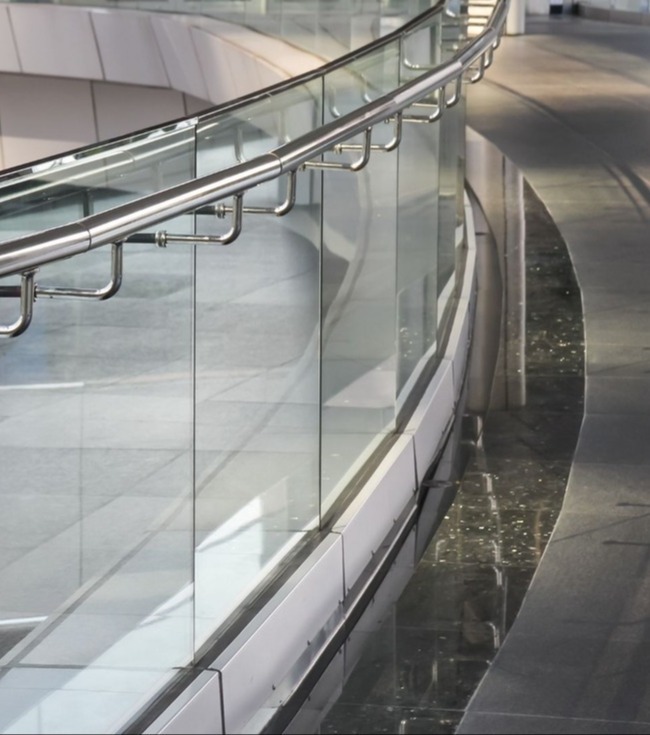 Glass railing in modern office hallway setting