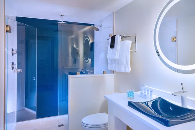 Interior Bathroom with Back Painted Glass Sink and Shower Wall