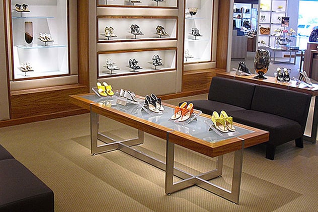 Retail glass fixtures shown in womens shoe store