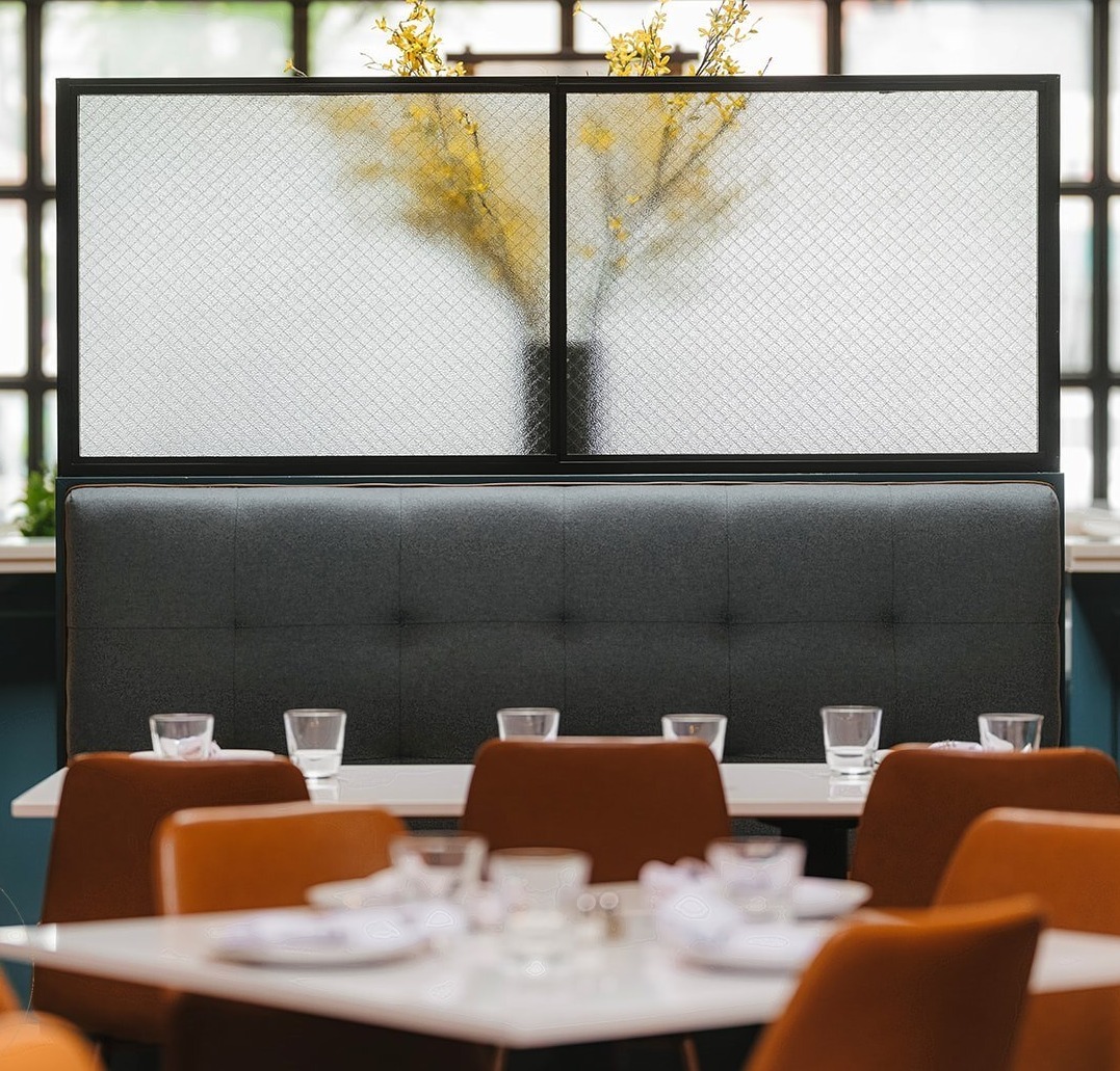 Decorative Glass behind modern dining setting in restaurant