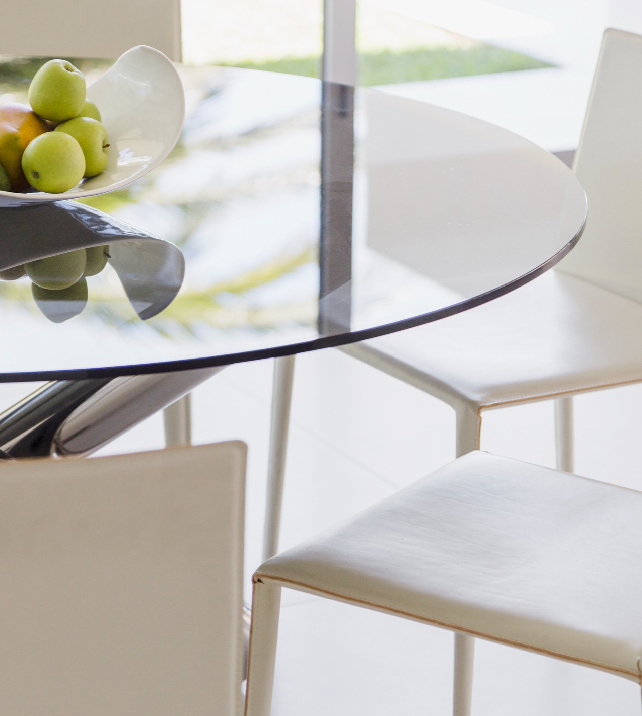 Modern circular glass table with fruit in the center