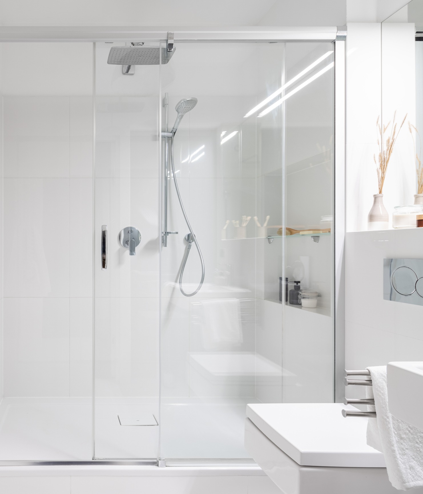 Modern shower with white styling and glass doors