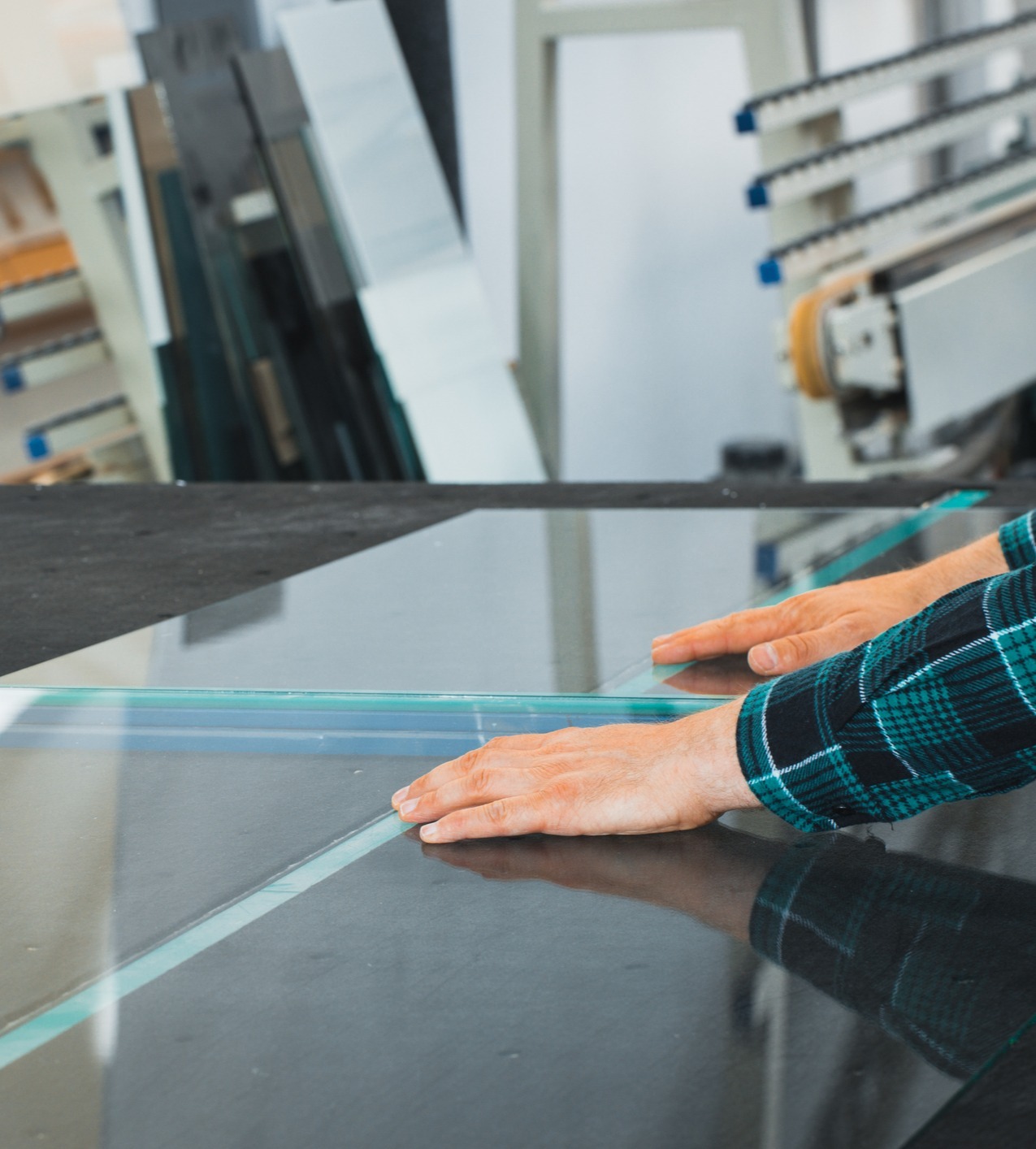 Worker cutting and splitting glass to size