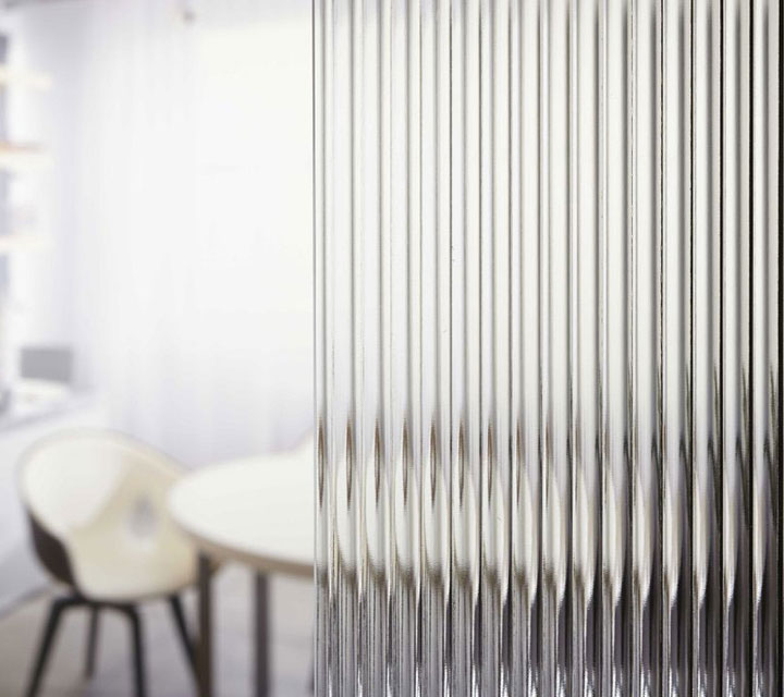 Reeded Glass in front of small desk with chairs