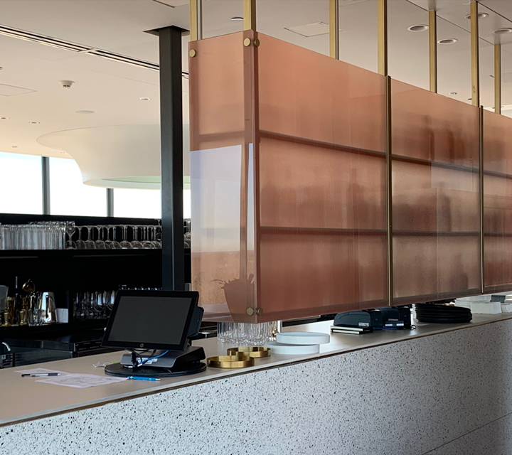 Copper colored laminated glass in bar area Copper colored laminated glass in bar area
